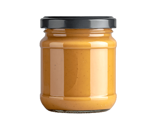 Jar of peanut butter with a black lid on a white background